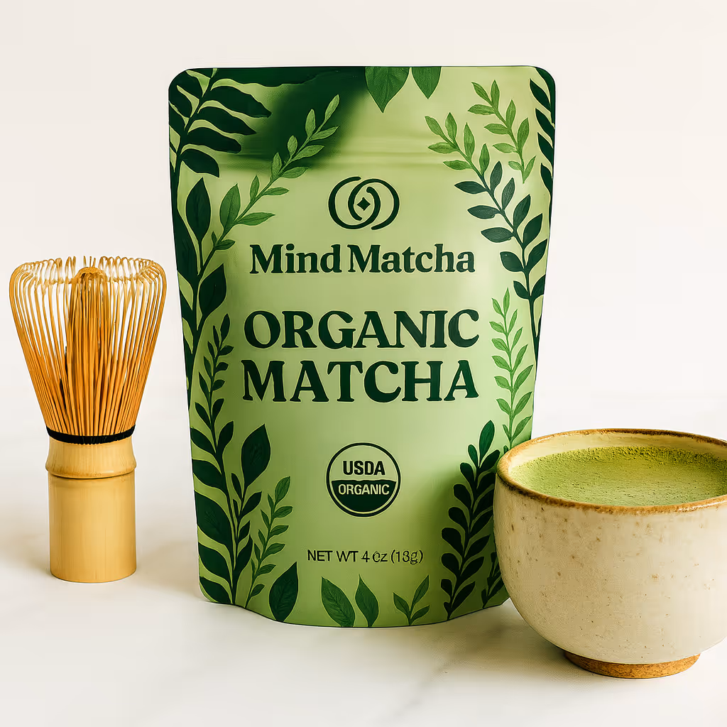 Organic Matcha powder, next to a bamboo whisk and a cup of matcha